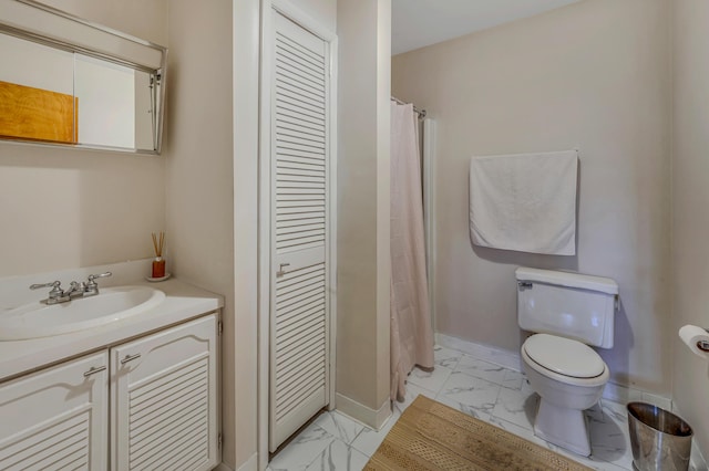 full bathroom featuring baseboards, toilet, a closet, marble finish floor, and vanity