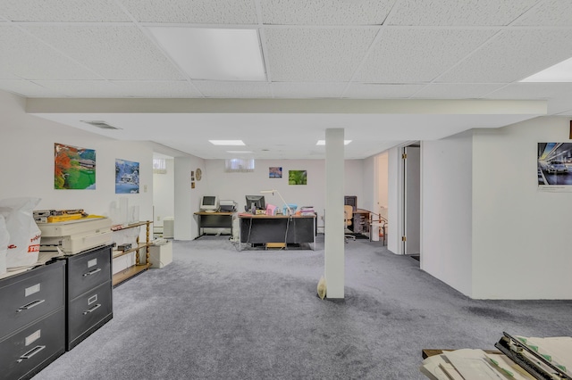 home office with carpet, visible vents, and a paneled ceiling