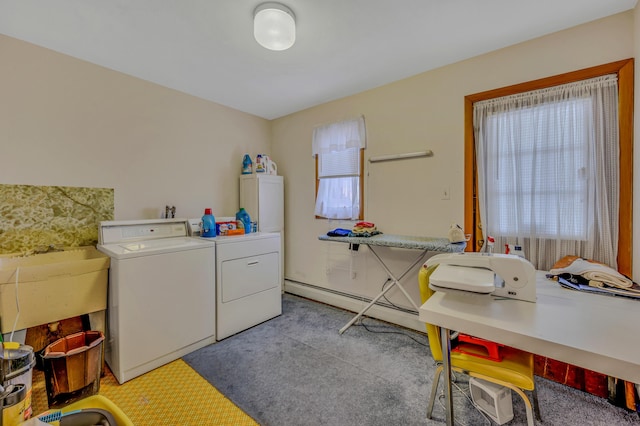 clothes washing area featuring laundry area, independent washer and dryer, and a sink