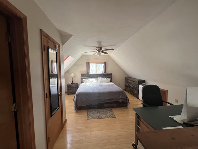 bedroom featuring light wood-type flooring, a ceiling fan, and vaulted ceiling