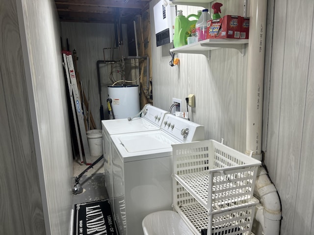 clothes washing area with independent washer and dryer, water heater, and laundry area