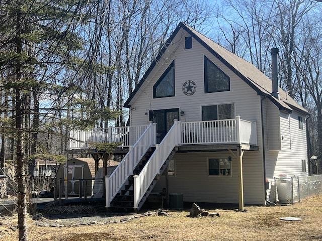 back of house featuring stairway, cooling unit, and a wooden deck