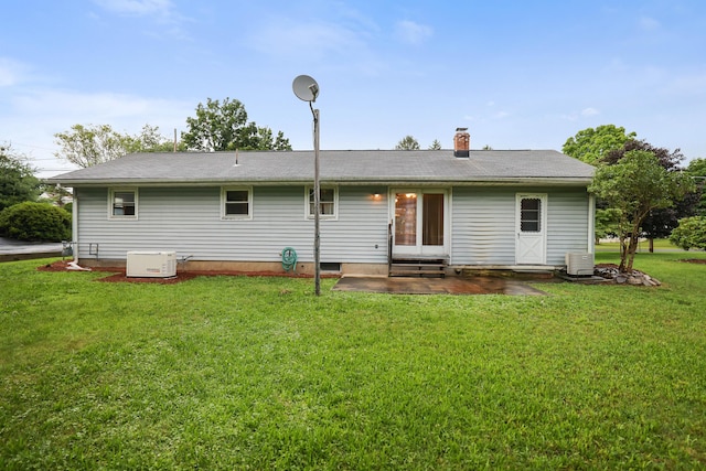 1703 Wallace St, Stroudsburg, PA 18360 - back of property featuring entry steps, a lawn, a chimney, and a patio area