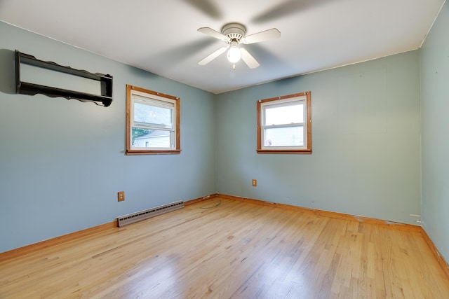1703 Wallace St, Stroudsburg, PA 18360 - empty room with healthy amount of natural light, a baseboard radiator, wood finished floors, and a ceiling fan