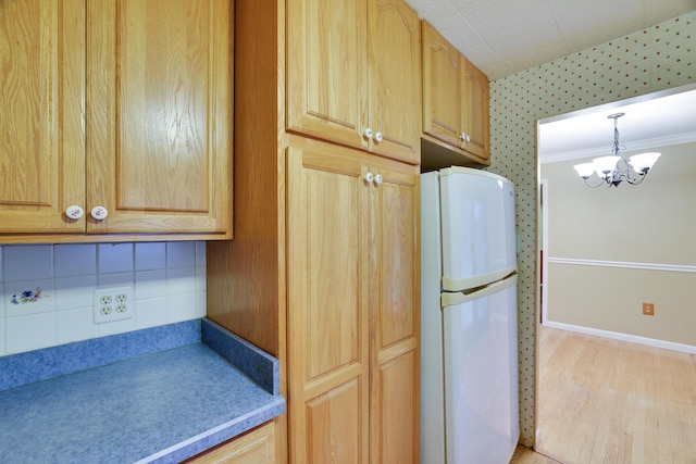 1703 Wallace St, Stroudsburg, PA 18360 - kitchen featuring freestanding refrigerator, a chandelier, light wood-style floors, wallpapered walls, and light brown cabinets