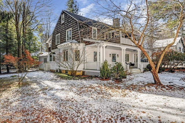 view of snow covered exterior with a porch