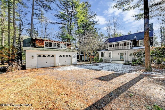 exterior space featuring a porch and a garage