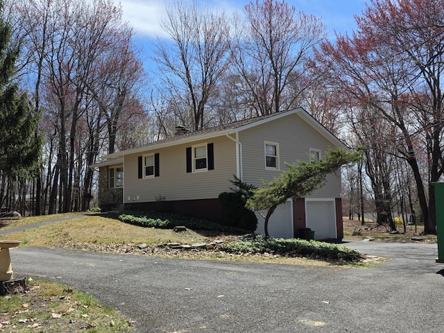 166 Applewood Dr, Swiftwater, PA 18370 - view of front facade featuring an attached garage, a chimney, and asphalt driveway