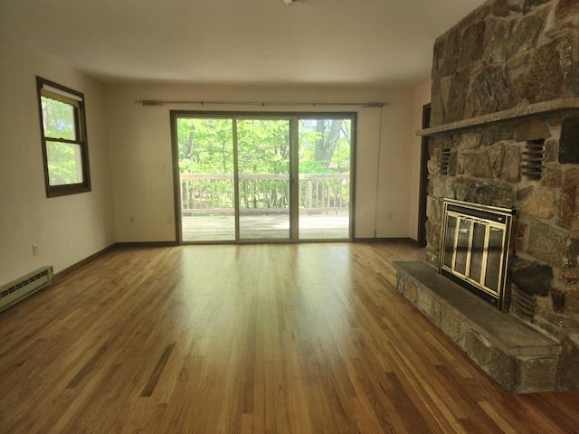 166 Applewood Dr, Swiftwater, PA 18370 - unfurnished living room featuring a fireplace, wood finished floors, and baseboards