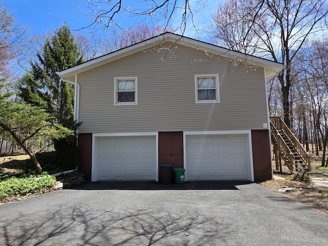 166 Applewood Dr, Swiftwater, PA 18370 - view of side of property with driveway, a garage, and stairway