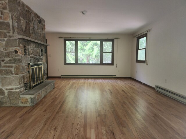 166 Applewood Dr, Swiftwater, PA 18370 - unfurnished living room featuring a fireplace, wood finished floors, and baseboards