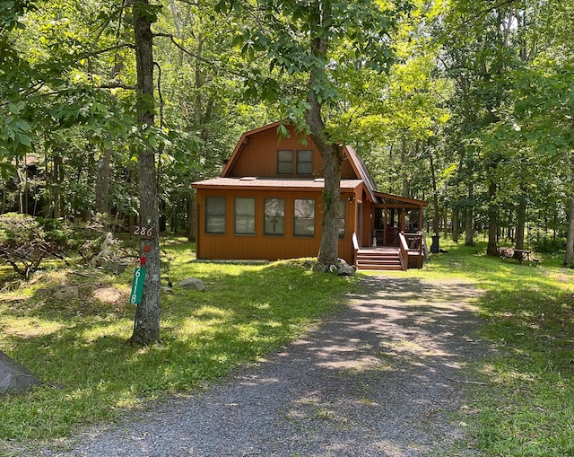 6118 Decker Rd, Bushkill, PA 18324 - view of front of home with gravel driveway, covered porch, and a wooded view