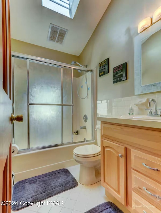 bathroom with enclosed tub / shower combo, toilet, a skylight, vanity, and visible vents