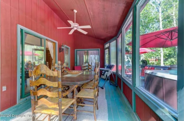 sunroom / solarium with ceiling fan and vaulted ceiling