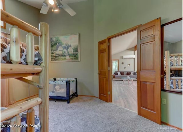 bedroom with a wall mounted AC and carpet flooring