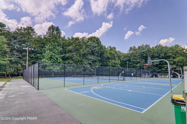 view of sport court with community basketball court, fence, and a tennis court