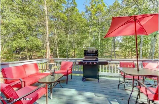 wooden terrace featuring grilling area and an outdoor living space