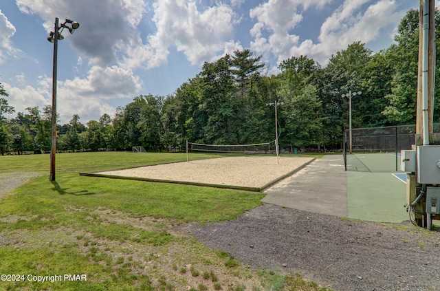 surrounding community featuring fence and volleyball court