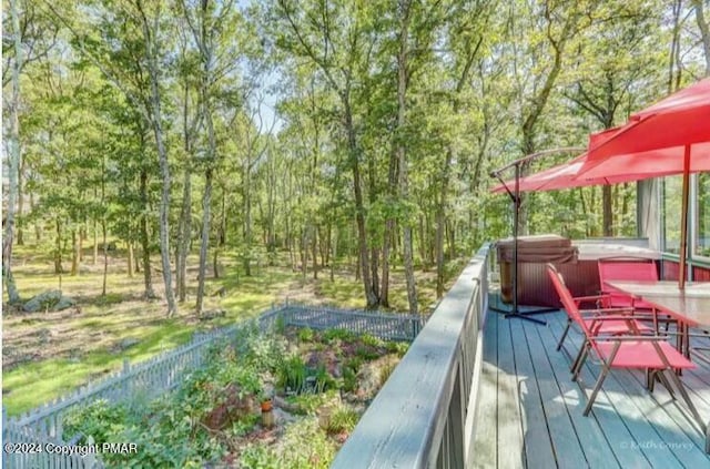 deck with fence and a hot tub