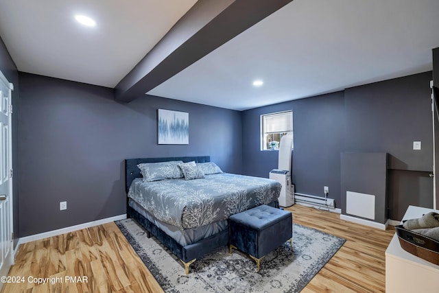 bedroom with hardwood / wood-style flooring, a baseboard radiator, and beamed ceiling