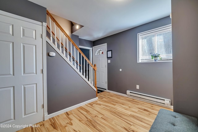 entryway with a baseboard radiator and hardwood / wood-style floors