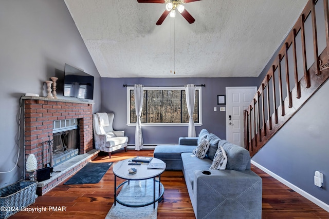 living room with lofted ceiling, a brick fireplace, a textured ceiling, dark hardwood / wood-style floors, and ceiling fan