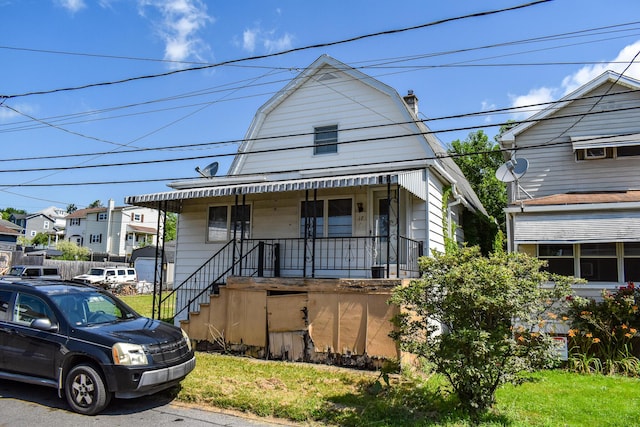 17 E Charles St, Plains Township, PA 18705 - view of front of house with a gambrel roof, a porch, and a chimney