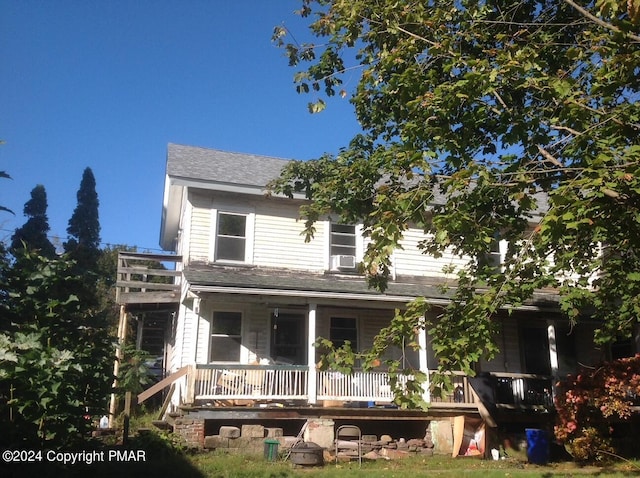 view of front of house featuring cooling unit and covered porch