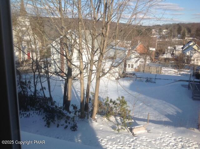 view of yard layered in snow