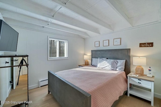 bedroom with beamed ceiling, a baseboard radiator, and light wood-style floors