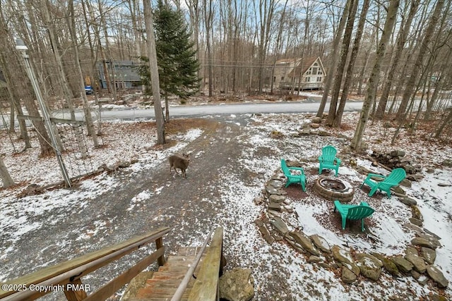 snowy yard featuring a fire pit