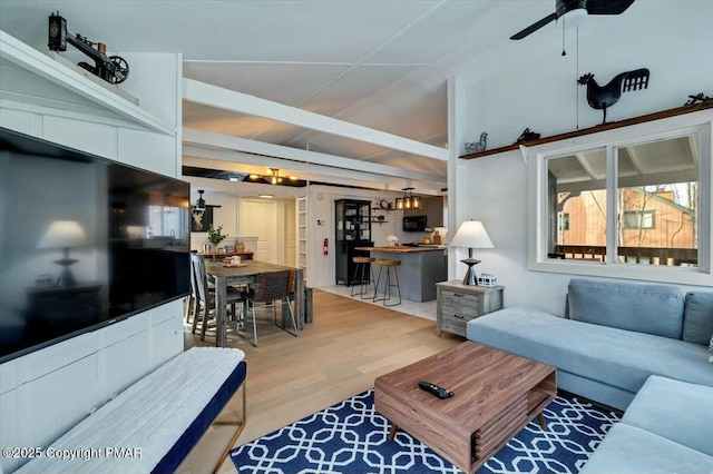 living area with wood finished floors and a ceiling fan