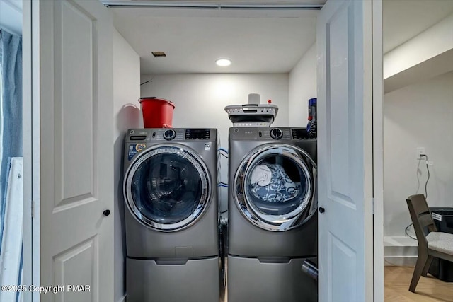 clothes washing area featuring laundry area and independent washer and dryer