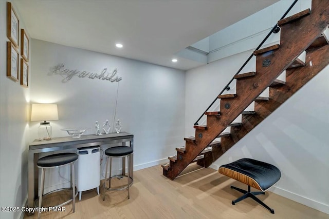 bar with recessed lighting, stairway, baseboards, and wood finished floors