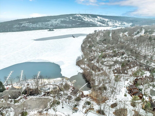 snowy aerial view featuring a mountain view