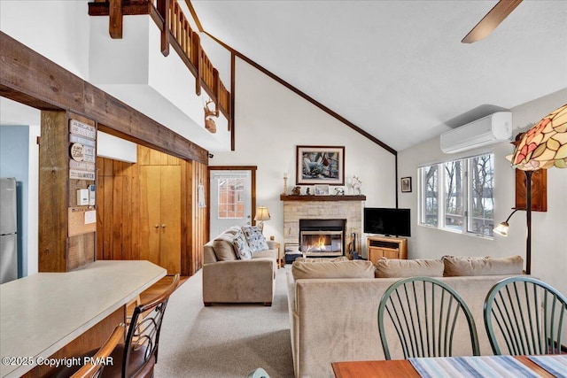 carpeted living area with high vaulted ceiling, a wall unit AC, and a fireplace