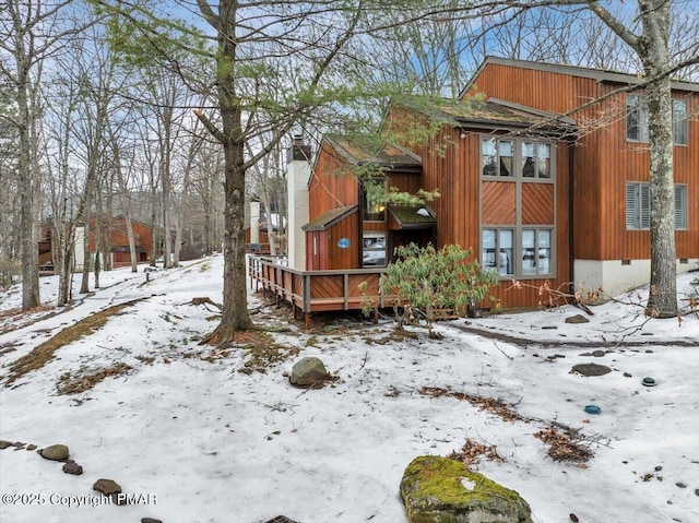 101 Ruffed Grouse Ct, Lake Harmony, PA 18624 - view of snowy exterior featuring a chimney and a wooden deck