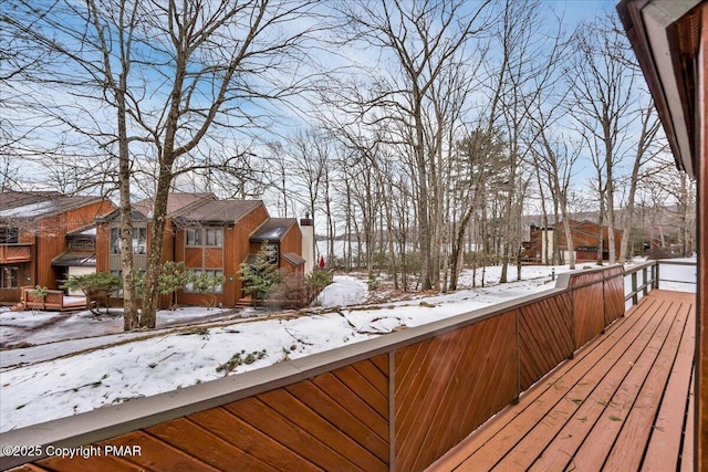 snow covered deck with a residential view