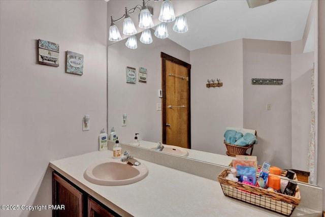 bathroom featuring a chandelier and vanity