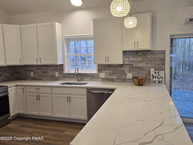 kitchen with a sink, light stone counters, white cabinetry, appliances with stainless steel finishes, and decorative backsplash