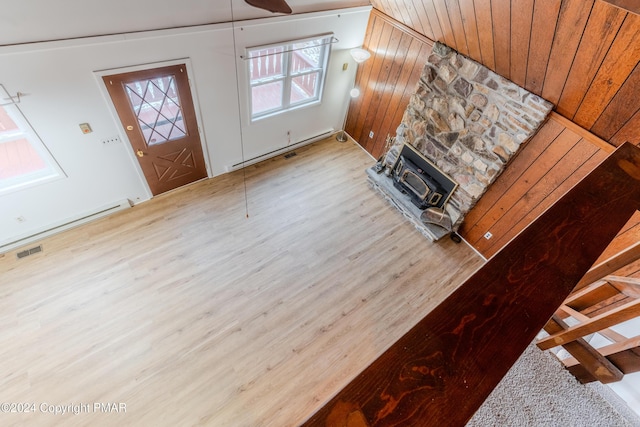 living room featuring visible vents, light wood-style flooring, and baseboard heating