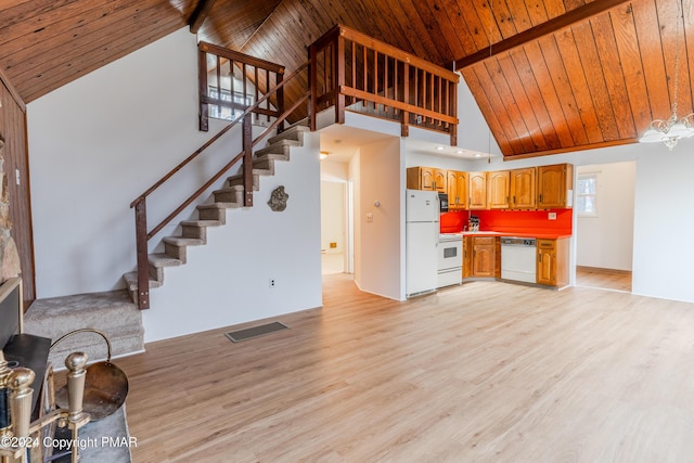 unfurnished living room with wooden ceiling, visible vents, beamed ceiling, and light wood-style flooring