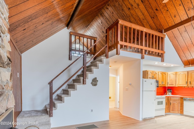 stairs featuring high vaulted ceiling, beamed ceiling, wood finished floors, and wood ceiling