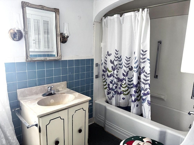 221 Diamond St, Pen Argyl, PA 18072 - full bathroom featuring tile walls, vanity, shower / tub combo with curtain, and a wainscoted wall