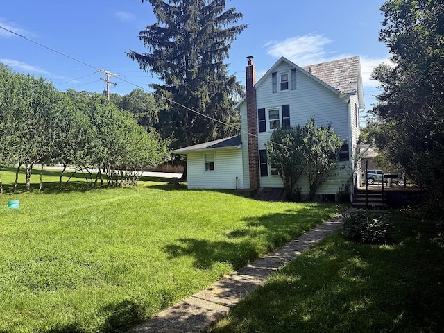 221 Diamond St, Pen Argyl, PA 18072 - rear view of house with a chimney, a lawn, a wooden deck, and a high end roof
