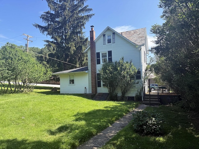 221 Diamond St, Pen Argyl, PA 18072 - rear view of property with a chimney, a lawn, a wooden deck, and a high end roof