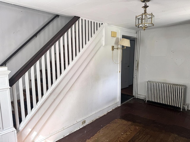 221 Diamond St, Pen Argyl, PA 18072 - stairway with radiator, hardwood / wood-style flooring, and a chandelier