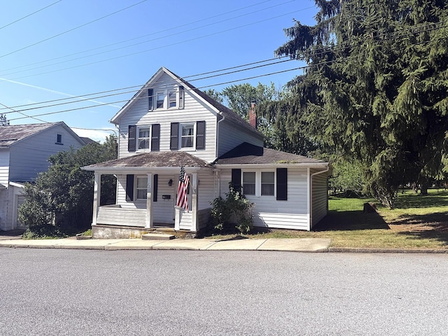 221 Diamond St, Pen Argyl, PA 18072 - view of front facade with covered porch, a chimney, and roof with shingles