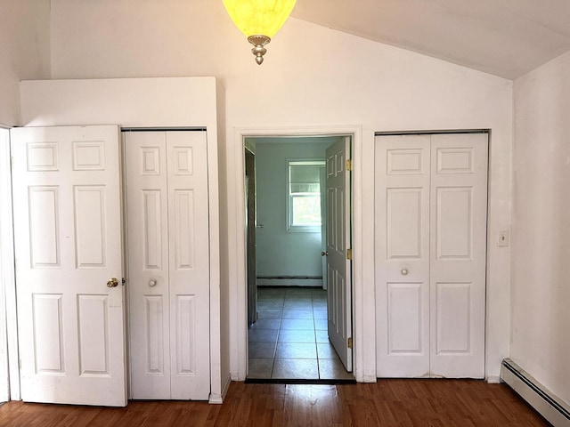 221 Diamond St, Pen Argyl, PA 18072 - unfurnished bedroom with a baseboard heating unit, lofted ceiling, and dark wood finished floors