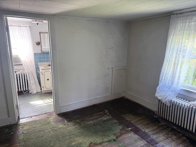 221 Diamond St, Pen Argyl, PA 18072 - empty room with radiator heating unit, crown molding, and wood-type flooring